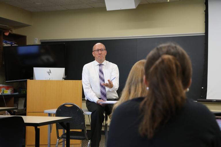 Faculty member lecturing to students in a Holy Family classroom